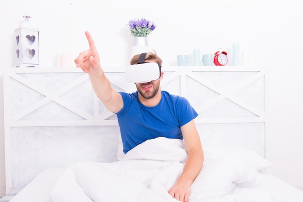 Return to reality Man explore vr while relaxing in bed Awakening from virtual reality VR technology and future Conscious awakening VR communication Exciting impressions Gaming augmented space