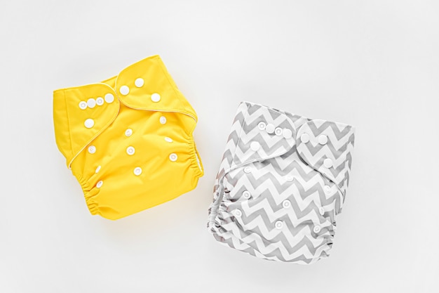 Reusable cloth baby diapers. Eco friendly cloth nappies on a white background. Sustainable lifestyle.  Zero waste concept.