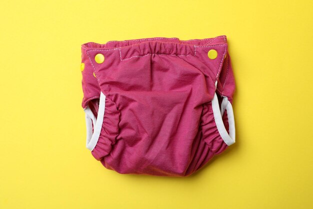 Reusable diapers on yellow background, close up