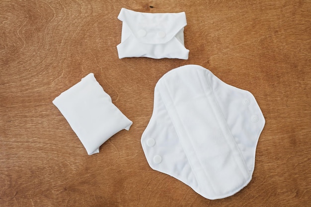 Reusable eco natural pads for menstrual days flat lay White feminine washable healthy and eco friendly pads Stop plastic pollution Free from perfume and chlorine Zero waste lifestyle