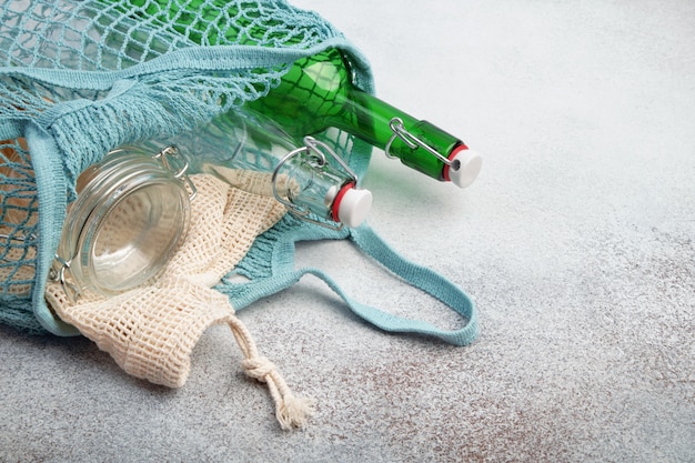 Reusable glass bottles and jars in mesh bag