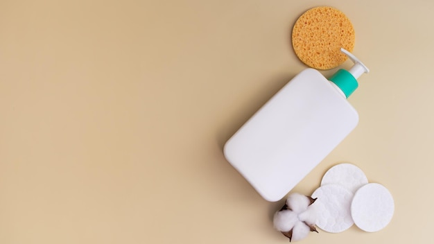 Reusable makeup remover pad and cleansing product in white bottle with dispenser