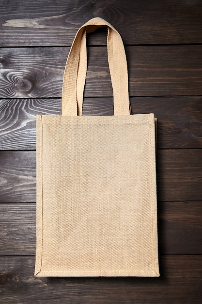 Reusable shopping bag on brown wooden surface