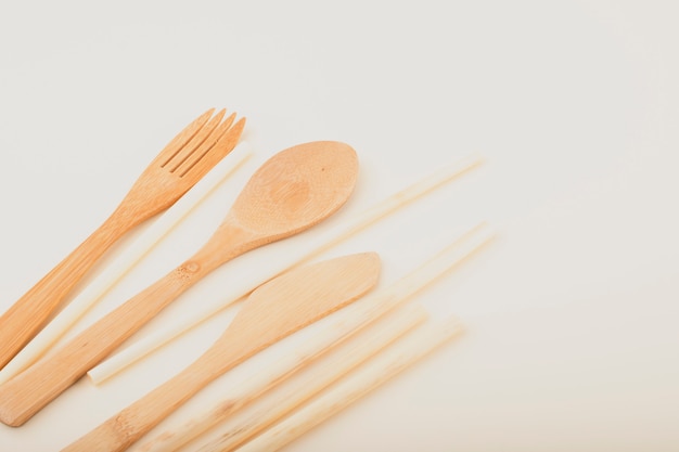 Reusable wooden kitchen utensils, fork, knife, spoon, wheat tubes. Zero waste concept, environmentally friendly items.