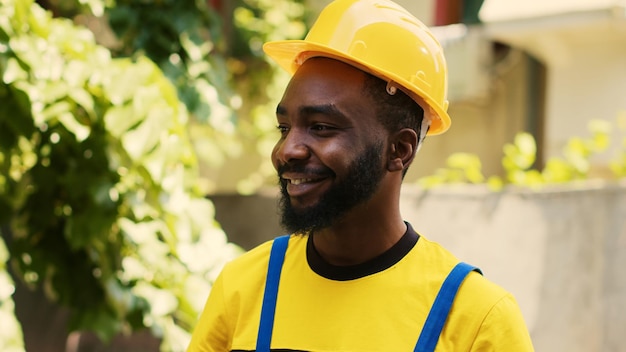 Revealing shot of smiling repairman happy with freon levels in outdoor condenser while using manometer to accurately measure HVAC system pressure, ensuring optimal cooling performance and efficiency