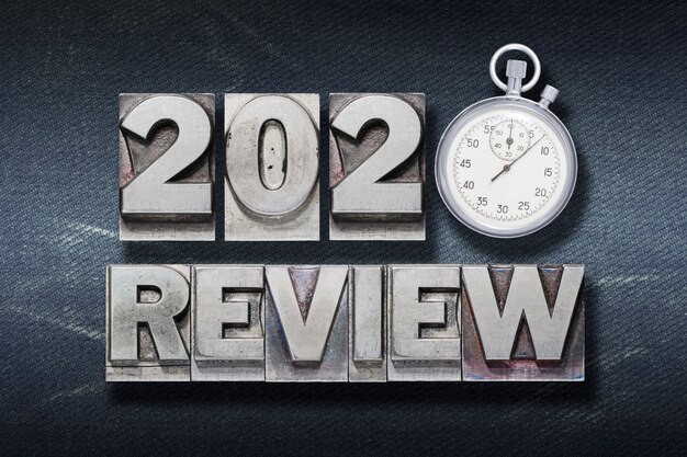 Review 2020 phrase made from metallic letterpress with stopwatch