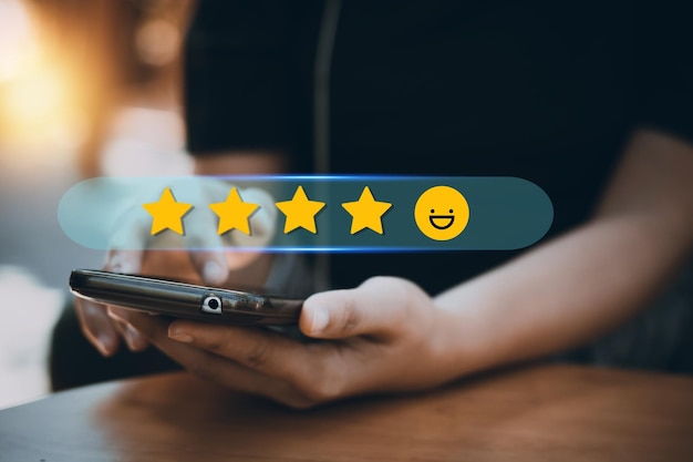 Review rating and feedback 5 stars the best and excellent\
admire by reviewer close up on customer hand pressing on smartphone\
screen with gold five star