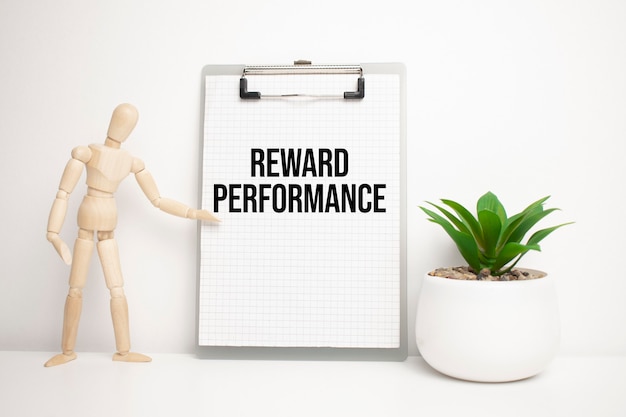 REWARD PERFORMANCE sign on small wood board rest on the easel with medical stethoscope