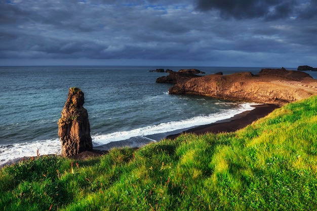 Reynisfjara black sand beach in Iceland. Reynisfyal Mountains