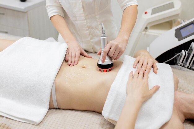 Photo rf body cavitation lifting procedure in a beauty salon ultrasound therapy to reduce fat