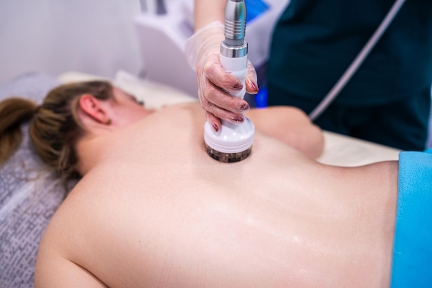 RF massage Hardware cosmetology Young woman getting rf lifting procedure in a beauty parlour