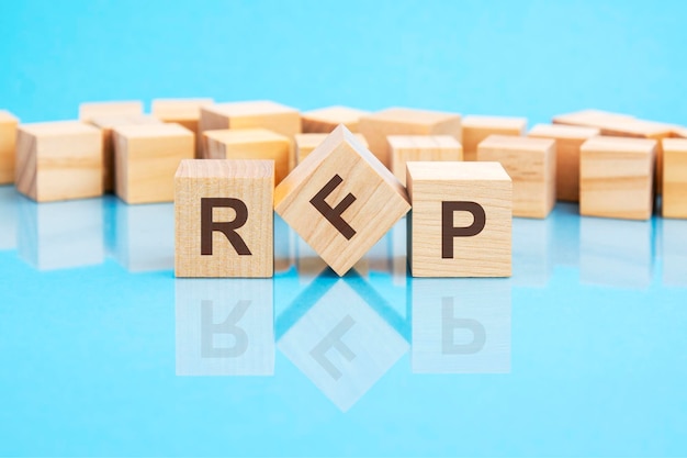 RFP text is made of wooden building blocks lying on the bright blue table concept