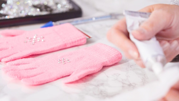 Rhinestone pink kids gloves with snowflake shapes.