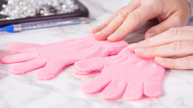 Rhinestone pink kids gloves with snowflake shapes.