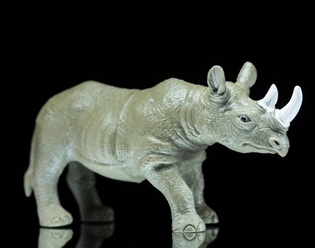 Rhino toy on a black background.