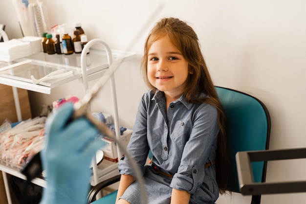 Rhinoscopy of child nose Consultation with doctor Children otolaryngologist calms child before procedure of rhinoscopy of nose