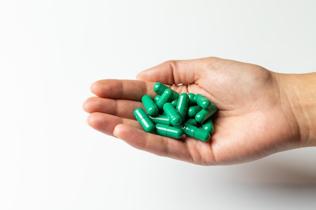 Rhodiola rosea capsules on a female hand