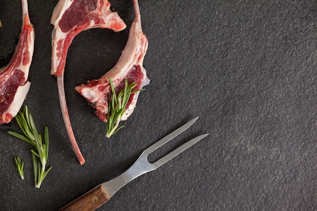 Rib chops, rosemary herb and fork