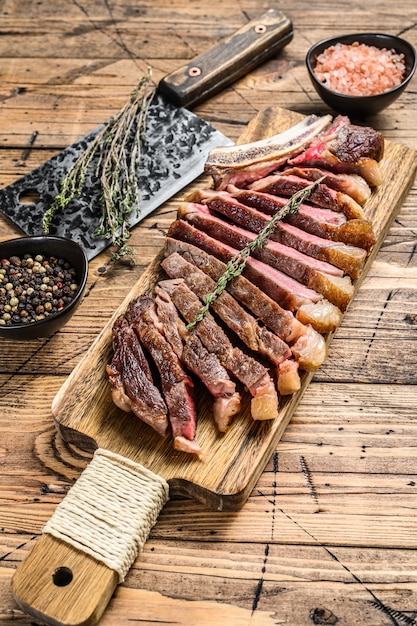 Rib eye steak on the bone with salt and pepper