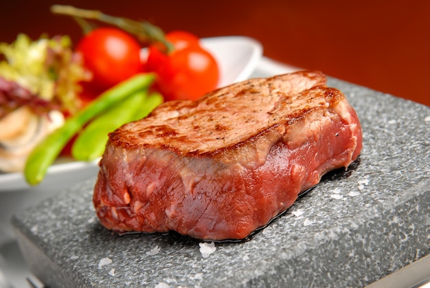 Rib-eye steak resting on the hot stone plate