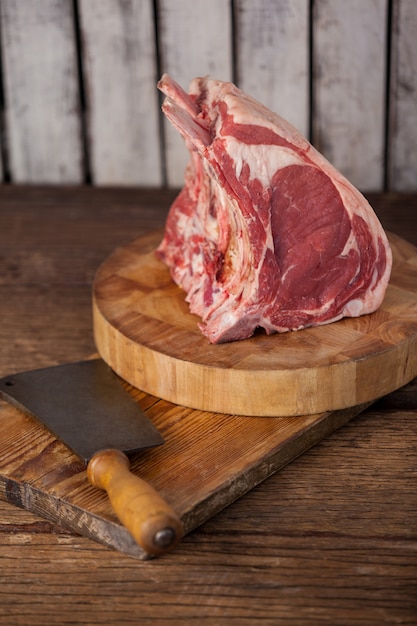 Rib rack and knife on wooden board