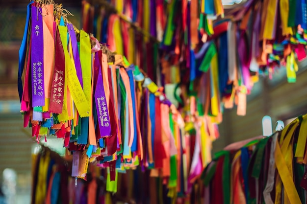 Ribbons tied on the tree of desires in a Buddhist temple