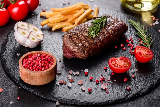 Ribeye steak with potatoes, onions and cherry tomatoes. Juicy steak with flavored butter