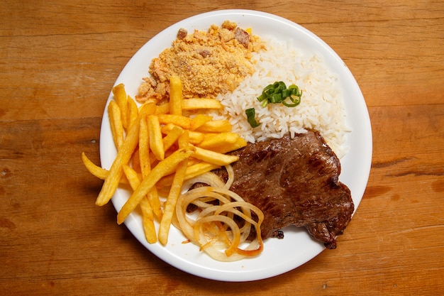 Rice, beans, french fries and beef steak