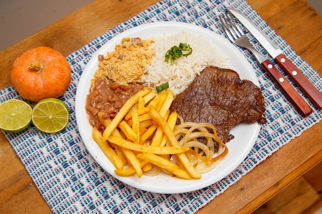 Rice, beans, french fries and beef steak