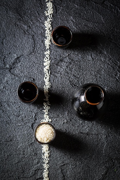 Rice and black ceramics to sake on black rock