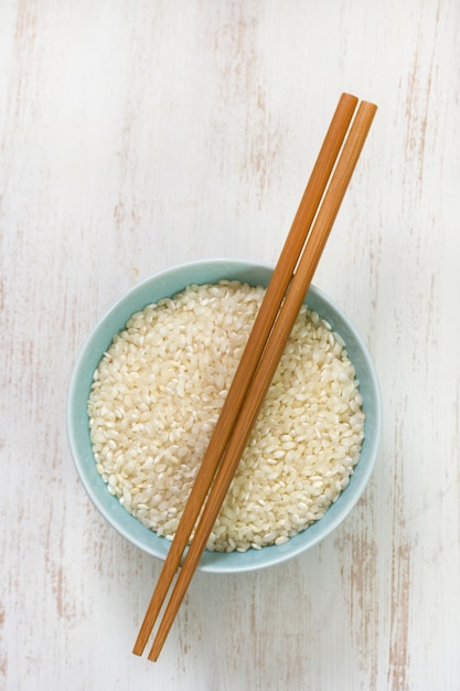 Rice in blue bowl in white background