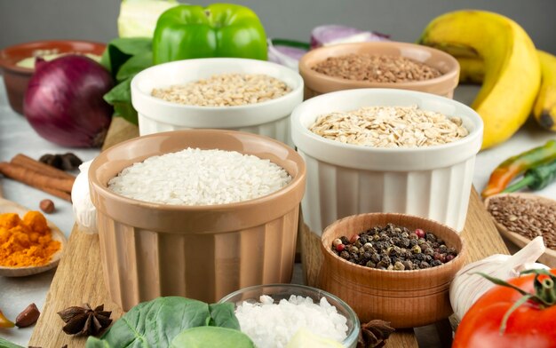 Rice in a bowl closeup in the background various cereals and vegetables. Healthy eating Great food. Vegetarian food. Culinary background for recipes. Food background.