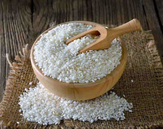 Rice in  bowl on wooden surface