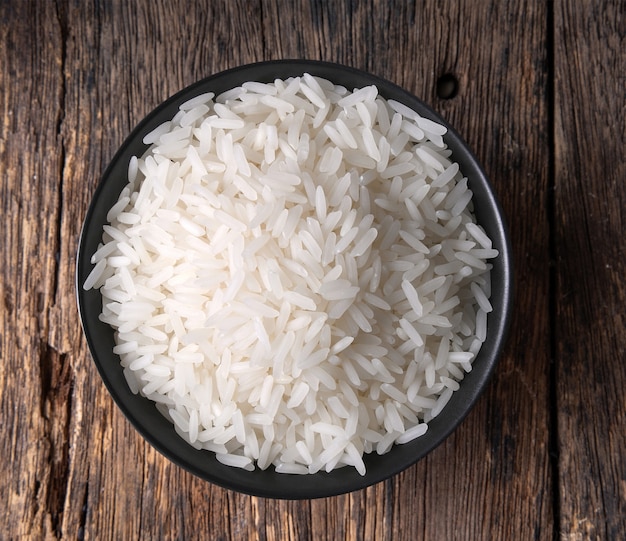 Rice in a bowl on wooden table