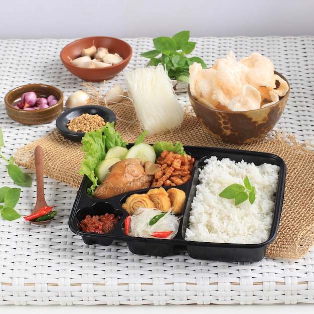 Rice Box or Indonesian Nasi Kotak with Soy Sauce Chicken, Oreg Tempeh, and Spicy Paste