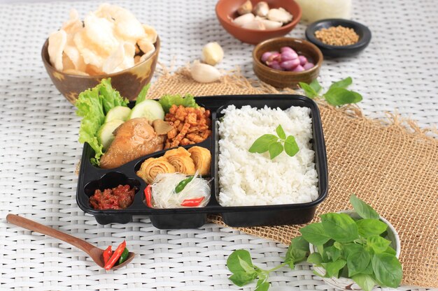 Rice Box or Indonesian Nasi Kotak with Soy Sauce Chicken, Oreg Tempeh, and Spicy Paste