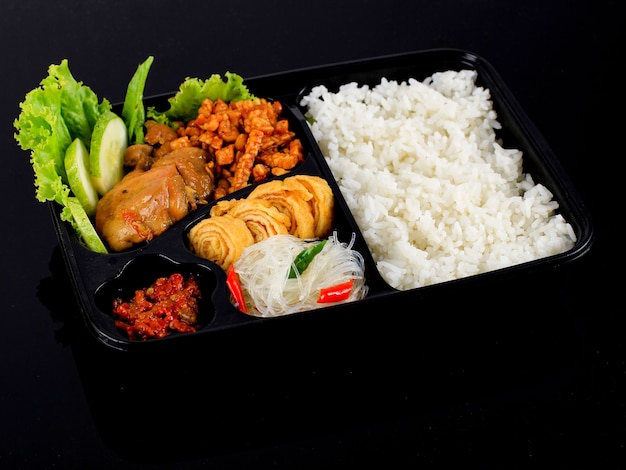 Rice Box or Indonesian Nasi Kotak with Soy Sauce Chicken Oreg Tempeh and Spicy Paste