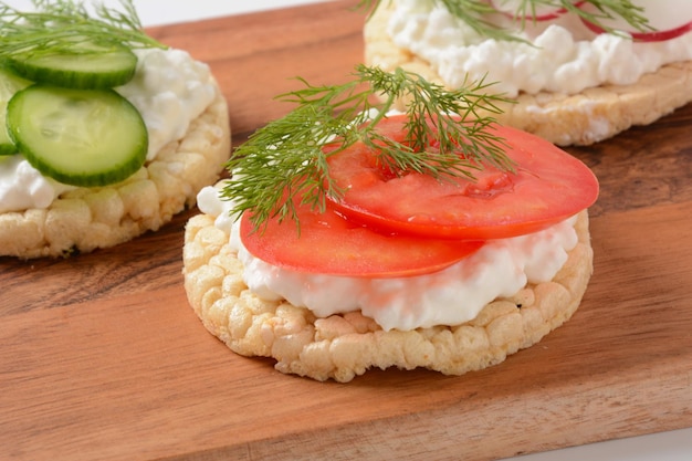 Rice bread Crispy bred Radish slices tomatoes and cucumber slices Cottage cheese and fresh dill