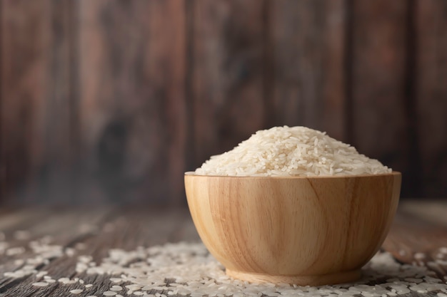 Rice in a brown bowl on the wooden table