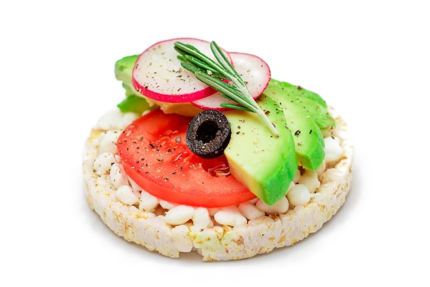 Rice cake sandwich with avocado tomato cottage cheese olives and radish