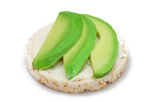 Rice cake sandwich with fresh avocado and cream cheese isolated