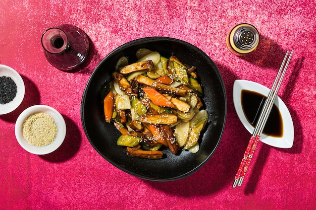 Rice cake with vegetables in the plate served with soy sauce