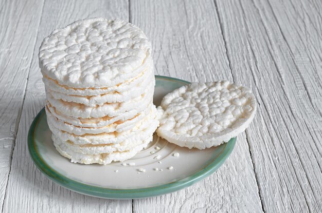 Rice cakes in plate on white wooden table