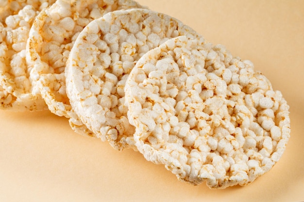 Rice cakes stacked in a diagonal row on a beige background