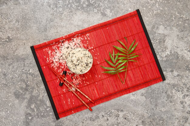 Rice chopsticks green palm leaves Asian cuisine flat lay