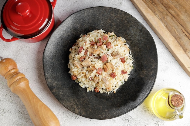 Photo rice dish with pieces of shank and bacon