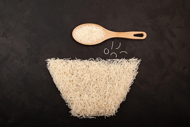 Rice flour Pasta gluten free Vermicelli on dark textured background Basmati rice. Uncooked noodles