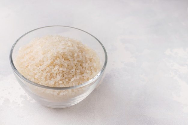 Rice in a glass bowl on white