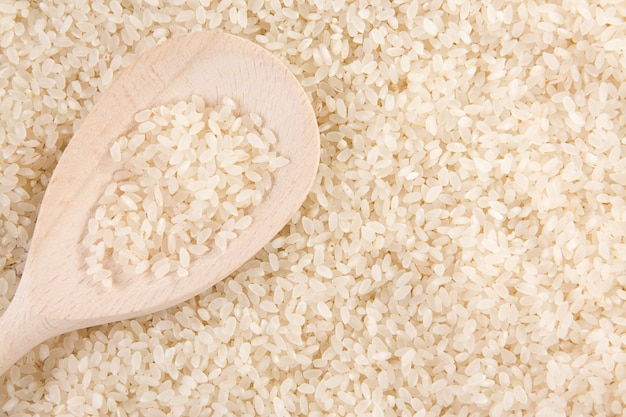 Rice grain in wooden spoon