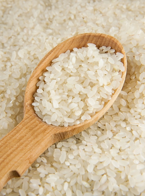 Rice grain in wooden spoon